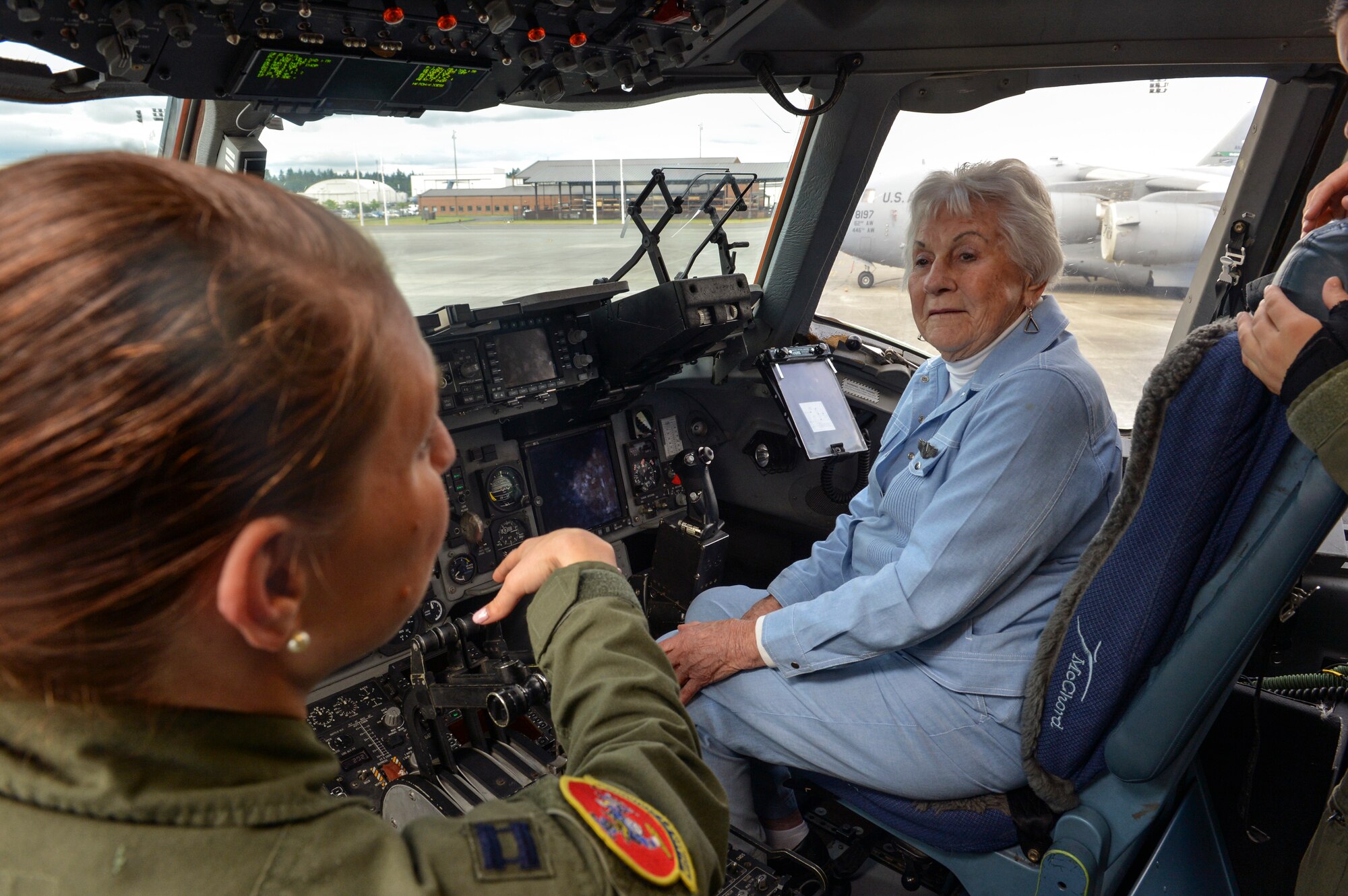 Capt. Rachael Deroche (left), 10th Airlift Squadron pilot, explains the technological advancements in aviation to Betty Dybbro, Woman Airforce Service Pilots veteran May 28, 2014, at Joint Base Lewis-McChord, Wash. Dybbro took the time to sit at the controls of a C-17 Globemaster III and ask pilots questions about flying the aircraft. (U.S. Air Force photo/Staff Sgt. Russ Jackson)