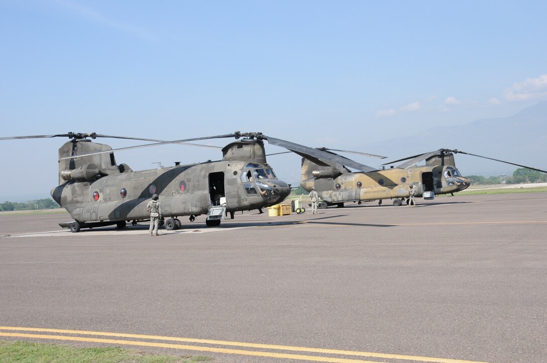 Two CH-47D Chinook crews perform pre-flight checks before departing Soto Cano Air Base, Honduras for the last time, May 28, 2014.  Two Chinooks attached to the 1-228th Aviation Regiment are slated to be replaced with the newer CH-47F model.  One of the helicopterss, affectionately known as "638", is the oldest active Chinook in the U. S. Army's inventory having flown in the Vietnam War.  (Photo by U. S. Air National Guard Capt. Steven Stubbs)
