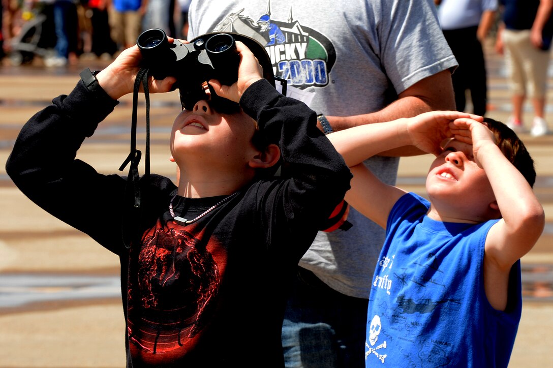 Spectators look to the sky to view aerial demonstrations at the air show and open house, May 24, 2014 at Cannon Air Force Base, N.M. Thousands travelled from the local area and bordering states to witness aerial demonstrations, view static displays and listen to musical performances at Cannon’s air Show and Open House. (U.S. Air Force photo/ Staff Sgt. Matthew Plew)