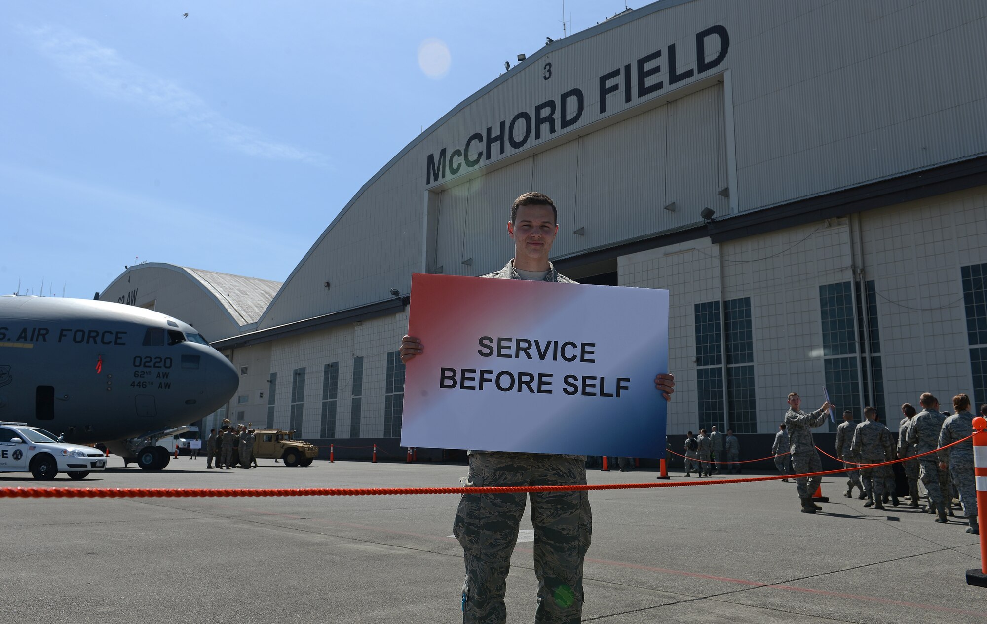 Airmen 1st Class Brandon Withee, 627th Logistics Readiness Squadron readiness spares apprentice, holds up a sign during the Sexual Assault and Prevention down day’s walk around May 22, 2014, at Joint Base Lewis-McChord, Wash. The walk around of the C-17 Globemaster III aircraft was part of Col. David Kumashiro’s, 62nd Airlift Wing commander, call to action of Airmen to follow him in upholding the duty to intervene. (U.S. Air Force photo/Airman 1st Class Jacob Jimenez)