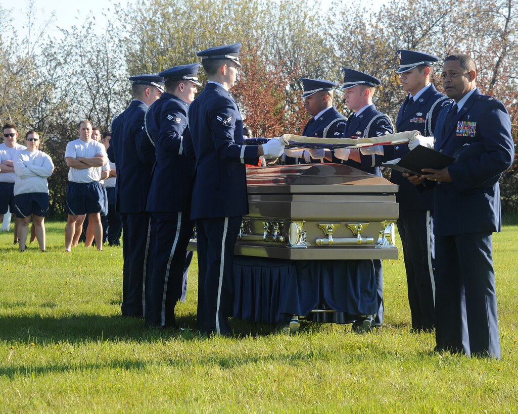 Chaplain (Maj.) Steven Dabbs concludes a final prayer while members of the Grand Forks Air Force Base Honor Guard conduct a flag-folding ceremony May, 22, 2014, during a DUI consequences demonstration on Grand Forks Air Force Base, N.D. As part of the demonstration, a simulated Airman fatality was shown to reinforce the severity and negative consequences of driving under the influence. (U.S. Air Force photo/Senior Airman Zachiah Roberson)
