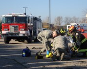 With hundreds of service members watching, base emergency responders show how they would assist victims of a crash involving a drunk driver during a demonstration for Wingman Day held May 22, 2014, on Grand Forks Air Force Base, N.D. The demonstration was one of several Wingman Day events designed to show how driving under influence can negatively affect not only an individual, but those around them as well. (U.S. Air Force photo/Senior Airman Zachiah Roberson)