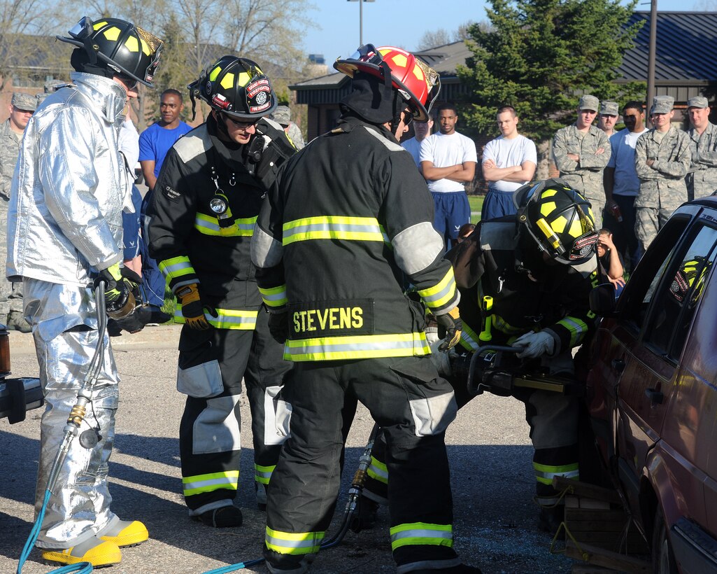 Grand Forks Air Force Base firemen use the Jaws of Life to cut through the door of a simulated crash victim’s vehicle during a demonstration on May 22, 2014, on Grand Forks Air Force Base, N.D. The demonstration was one of several Wingman Day events designed to show how driving under influence can negatively affect people’s lives and property. (U.S. Air Force photo/Senior Airman Zachiah Roberson)