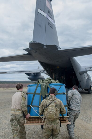 Combat controllers from the Kentucky Air National Guard’s 123rd Special Tactics Squadron load a container delivery system bundle onto a Kentucky Air National Guard C-130 Hercules at the Donnelly drop zone in the Pacific-Alaska Range Complex as part of Red Flag-Alaska on May 21, 2014. More than 100 Kentucky Airmen participated in the exercise from May 7 to 23. (U.S. Air National Guard photo by Master Sgt. Phil Speck)