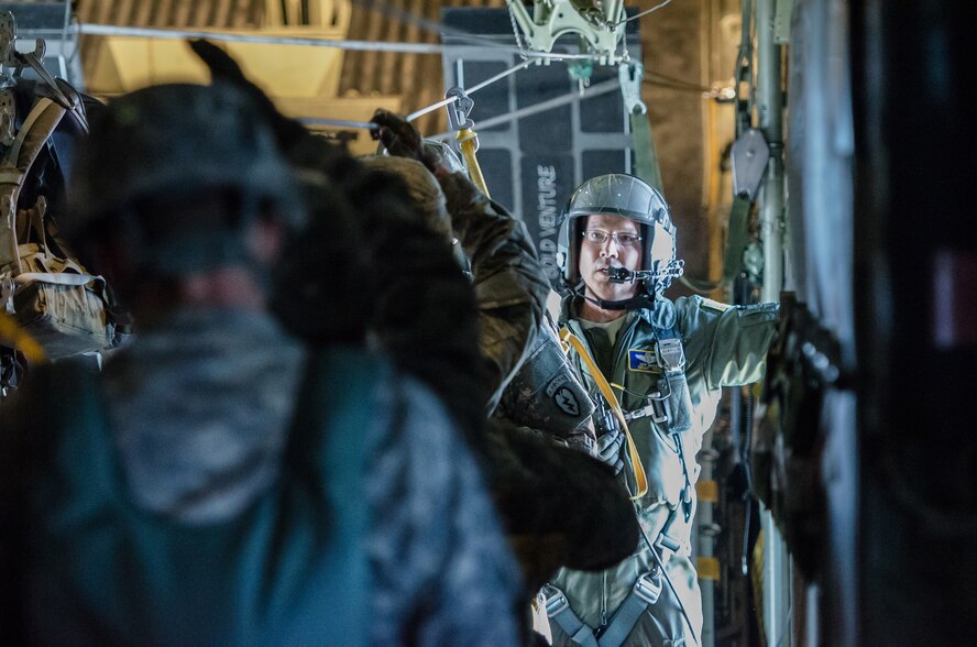 Chief Master Sgt. Jeffrey Brown, a loadmaster from the Kentucky Air National Guard’s 165th Airlift Squadron, prepares the paratroop door on a Kentucky Air Guard C-130 Hercules for Soldiers from the 2-377th Parachute Field Artillery Regiment, 4th IBCT 25 Infantry Division, while flying just north of Joint Base Elmendorf-Richardson, Alaska, on May 13, 2014. The jump was part of Red Flag-Alaska, a Pacific Command exercise designed to provide aircrews with realistic combat training. (U.S. Air National Guard photo by Master Sgt. Phil Speck)