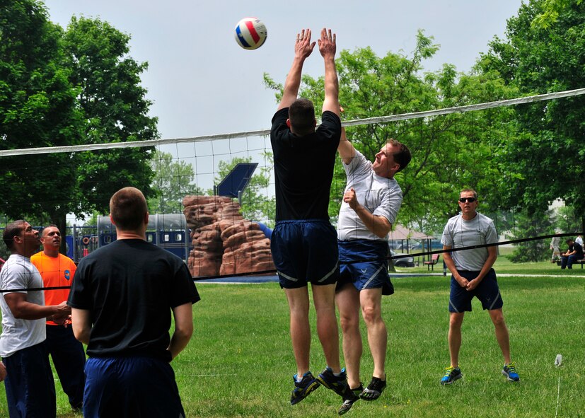 Airmen from Team Dover compete in the volleyball competition during Wingman Day May 22, 2014, at the Eagles Nest Park on Dover Air Force Base, Del. Rally point scoring was used to expedite the games. (U.S. Air Force photo/Staff Sgt. Elizabeth Morris)