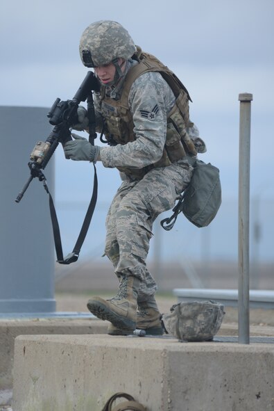 Senior Airman Zachary Parkman, of the 219th Security Forces Squadron, looks for anything suspicious during an exercise at a Minot Air Force Base, N.D., missile launch facility May 20, 2014. Parkman is one of several North Dakota Air National Guard enlisted members who are doing their annual training while performing the real-World mission of missile field security, which allows their active duty counterparts to catch up on other training and mission requirements.  (U.S. Air National Guard photo by SMSgt. David H. Lipp/Released)