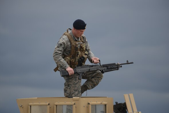 From right to left Senior Airman Scott Leithheiser, Senior Airman Trent Obrien, and Tech. Sgt. Cody Chick, all of the 219th Security Forces Squadron, return from the gate of a Minot Air Force Base, N.D., missile alert facility, after granting access to authorized personnel entering the facility May 20, 2014. The North Dakota Air National Guard enlisted members are doing their annual training while performing the real-World mission of missile field security, which allows their active duty counterparts to catch up on other training and mission requirements.  (U.S. Air National Guard photo by SMSgt. David H. Lipp/Released)
