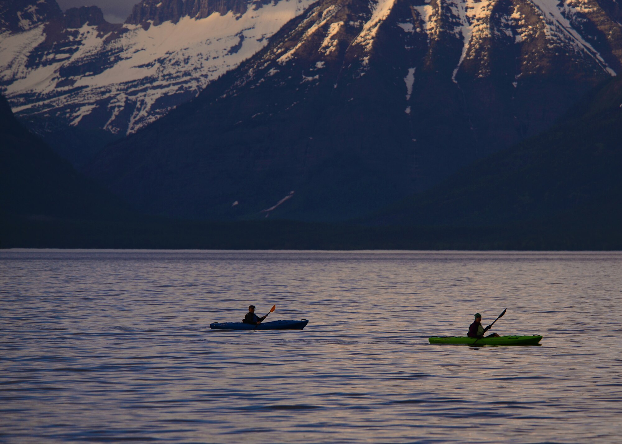 Two kayakers explore Lake McDonald near West Glacier National Park in Apgar Village, Mont. At 10 miles long and 500 feet deep as a result of glacial carving, Lake McDonald is the largest lake in the park and a central location for West Glacier and includes biking and hike trails ranging in easy to strenuous difficulty. (U.S. Air Force photo/Senior Airman Katrina Heikkinen)