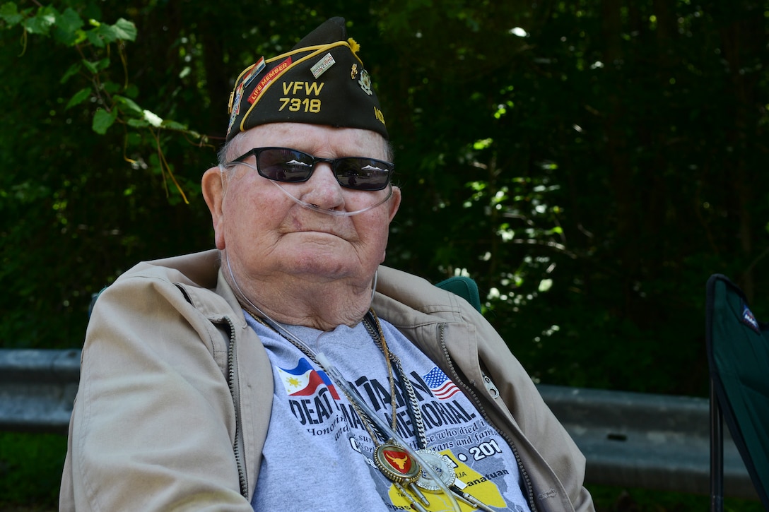 Retired U.S. Army Master Sgt. John Mims waits to greet event participants during the Third Annual Bataan Death March at the Dismal Swamp Trail in Chesapeake, Va, May 24, 2014. Mims is one of the last survivors of the WWII Bataan Death March of 1942. (U.S. Air Force photo by Airman 1st Class Devin Scott Michaels/Released)