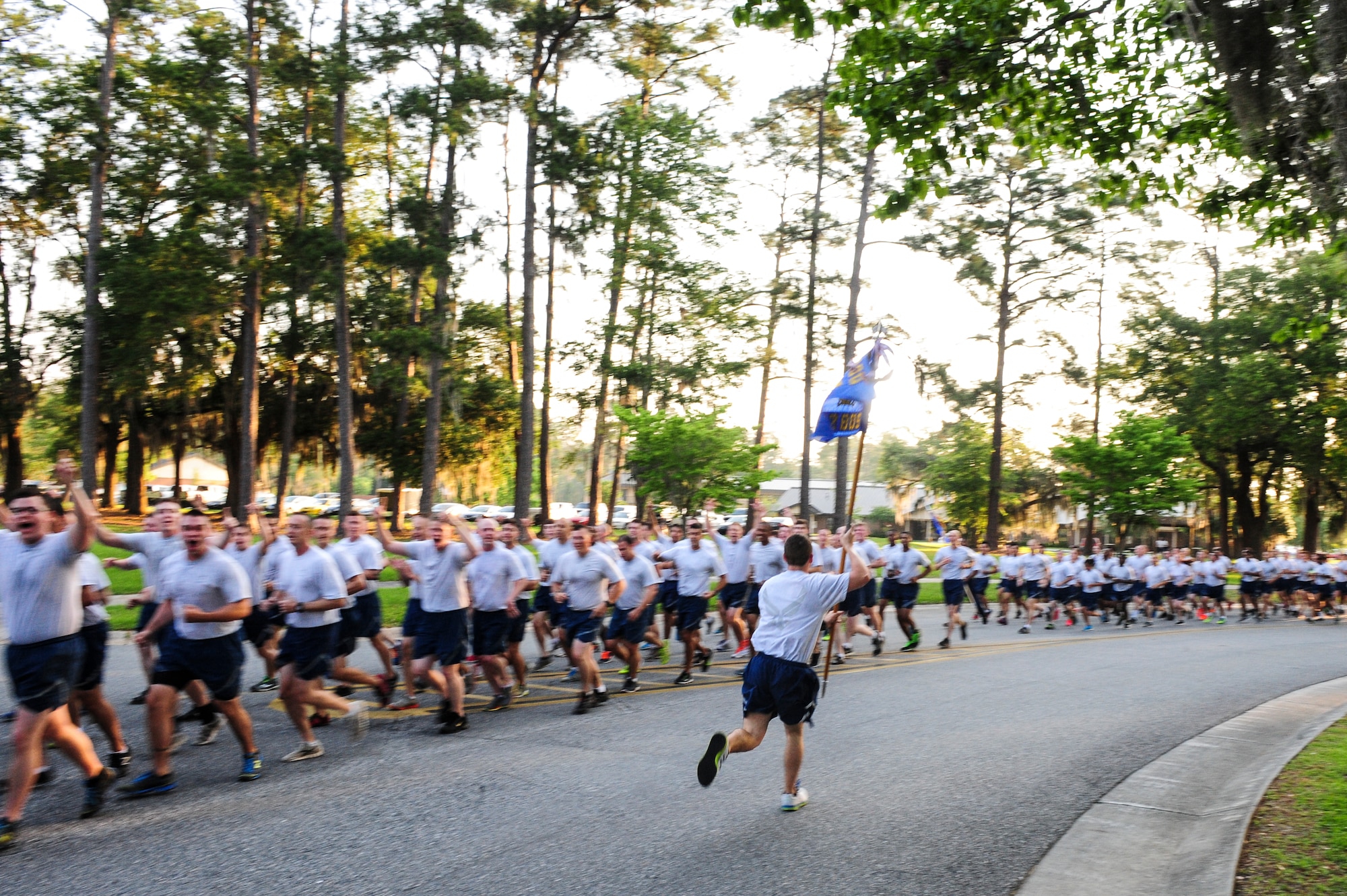 The guidon bearer for the 822d Base Defense Squadron circles his flight during a 2.3-mile run for Comprehensive Airman Fitness (CAF) Day on Moody Air Force Base, Ga., May 22, 2014. Physical, Spiritual, Social, and Mental fitness are the four pillars of the Air Force CAF program. (U.S. Air Force photo by Tech. Sgt. Joshua J. Garcia/Released) 