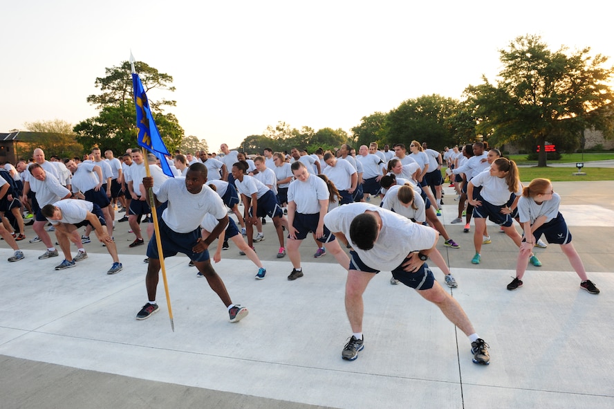 Airmen from the 23d Wing Staff Agencies stretch prior to starting the Comprehensive Airmen Fitness (CAF) Day 2.3-mile run on Moody Air Force Base, Ga., May 22, 2014. The run kicked off CAF Day, which consisted of small group discussions and Sexual Assault Prevention Response training. (U.S. Air Force photo by Tech. Sgt. Joshua J. Garcia/Released) 