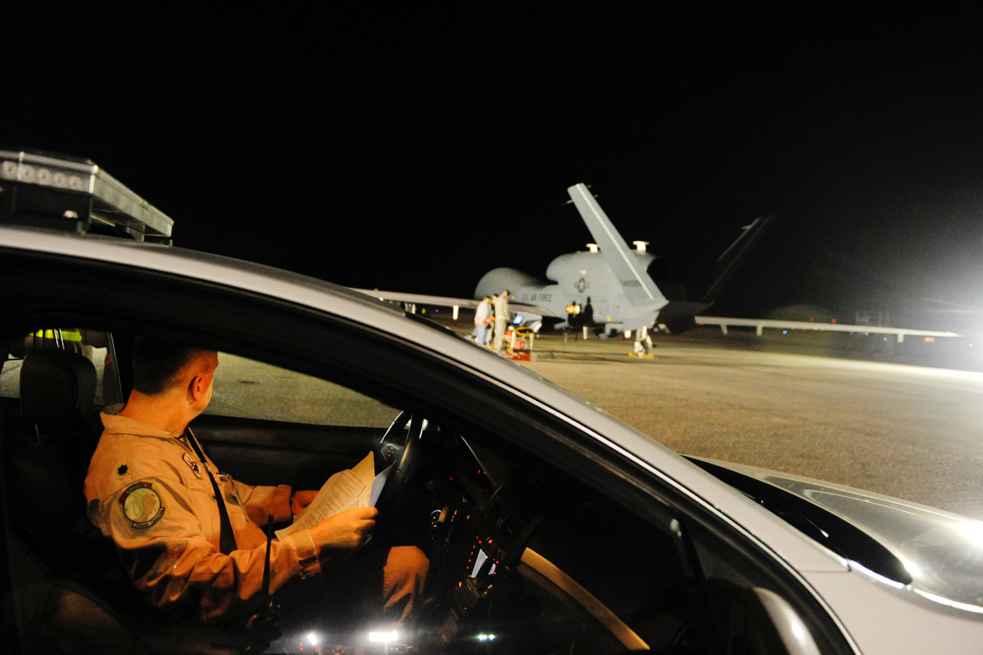 SOUTHWEST ASIA -- A U.S. Air Force Lt. Col. from the 99th Expeditionary Reconnaissance Squadron waits for an EQ-4 Global Hawk's first launch in November 2010. The Battlefield Airborne Communications Node, or BACN, program managed at Hanscom AFB, Mass., provides a critical capability to connect warfighters and recently was flown simultaneously on three EQ-4B Global Hawks to expand coverage. (U.S. Air Force photo by Staff Sgt. Eric Harris) 