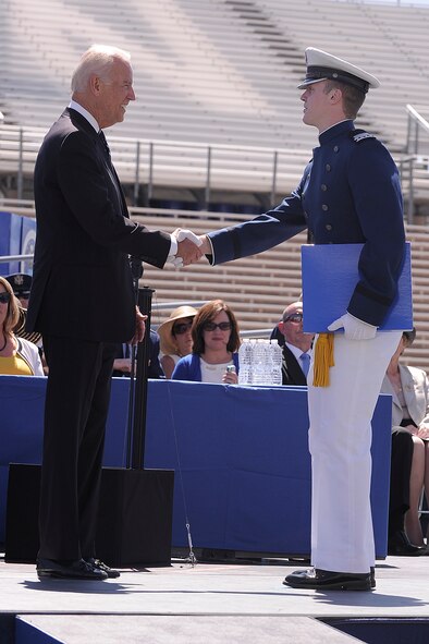 Senior David McCarthy receives his diploma from Vice President Joe Biden during the U.S. Air Force Academy Class of 2014 during commencement exercises at Falcon Stadium in Colorado Springs, Colo. May 28, 2014.  Cadet McCarthy was the  top cadet  in the class of 995 cadets who will receive their commission.  (Air Force photo/ Sarah Chambers)