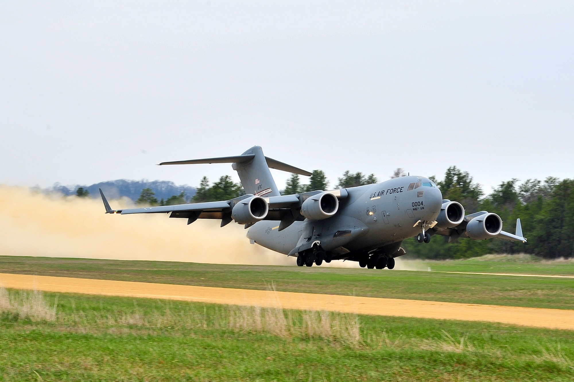 A 445th Airlift Wing C-17 Globemaster III takes off from the Young Air Assault Strip on May 7, 2014 during exercise Patriot Warrior at Fort McCoy, Wis. United States military reserve components from all branches participate in combined exercises Patriot Warrior, Global Medic, Diamond Saber and CSTX in preparation for upcoming deployments in joint environments. (U.S. Air Force photo by Master Sgt. Francisco V. Govea II/ Released)