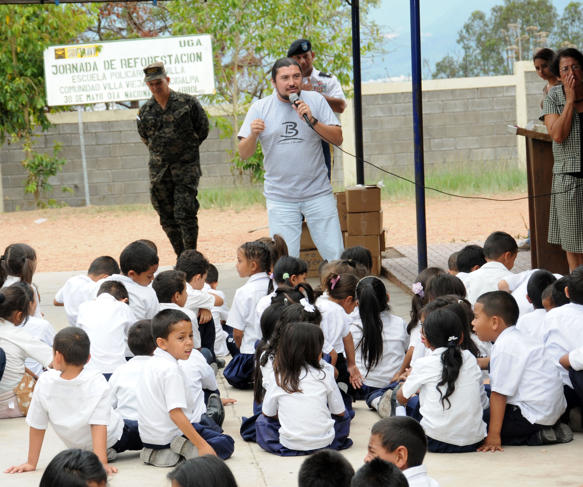 Trifilio Villela from Bride Ministries talks to children of the Policarpo Bonilla school about the improtance of proper hygiene.  Joint Task Force-Bravo, non-government organizations Clean the World, Bridge Ministries and Kick for Nick Foundation, the Honduran 21st Military Police Battalion and the Honduran National Police formed a partnership to distribute soap kits, backpacks with school supplies, tooth brushes and tooth paste, soccer balls and uniforms to students at eight Tegucigalpa, Honduras schools in a two-day event, May 20-21, 2014.  The group handed out over 4,200 soap kits, 600 backpacks, 150 tooth brushes and tooth paste, and 50 soccer balls.  (Photo by U. S. Air National Guard Capt. Steven Stubbs)