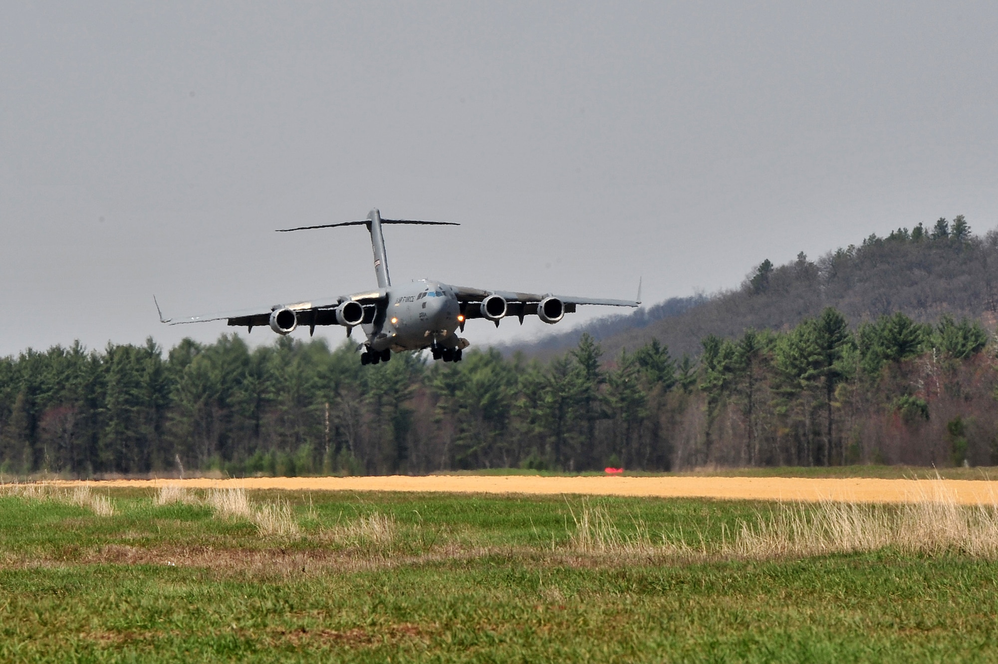 A 445th Airlift Wing C-17 Globemaster III lands at the Young Air Assault Strip on May 7, 2014 during exercise Patriot Warrior at Fort McCoy, Wis. United States military reserve components from all branches participate in combined exercises Patriot Warrior, Global Medic, Diamond Saber and CSTX in preparation for upcoming deployments in joint environments. (U.S. Air Force photo by Master Sgt. Francisco V. Govea II/ Released)