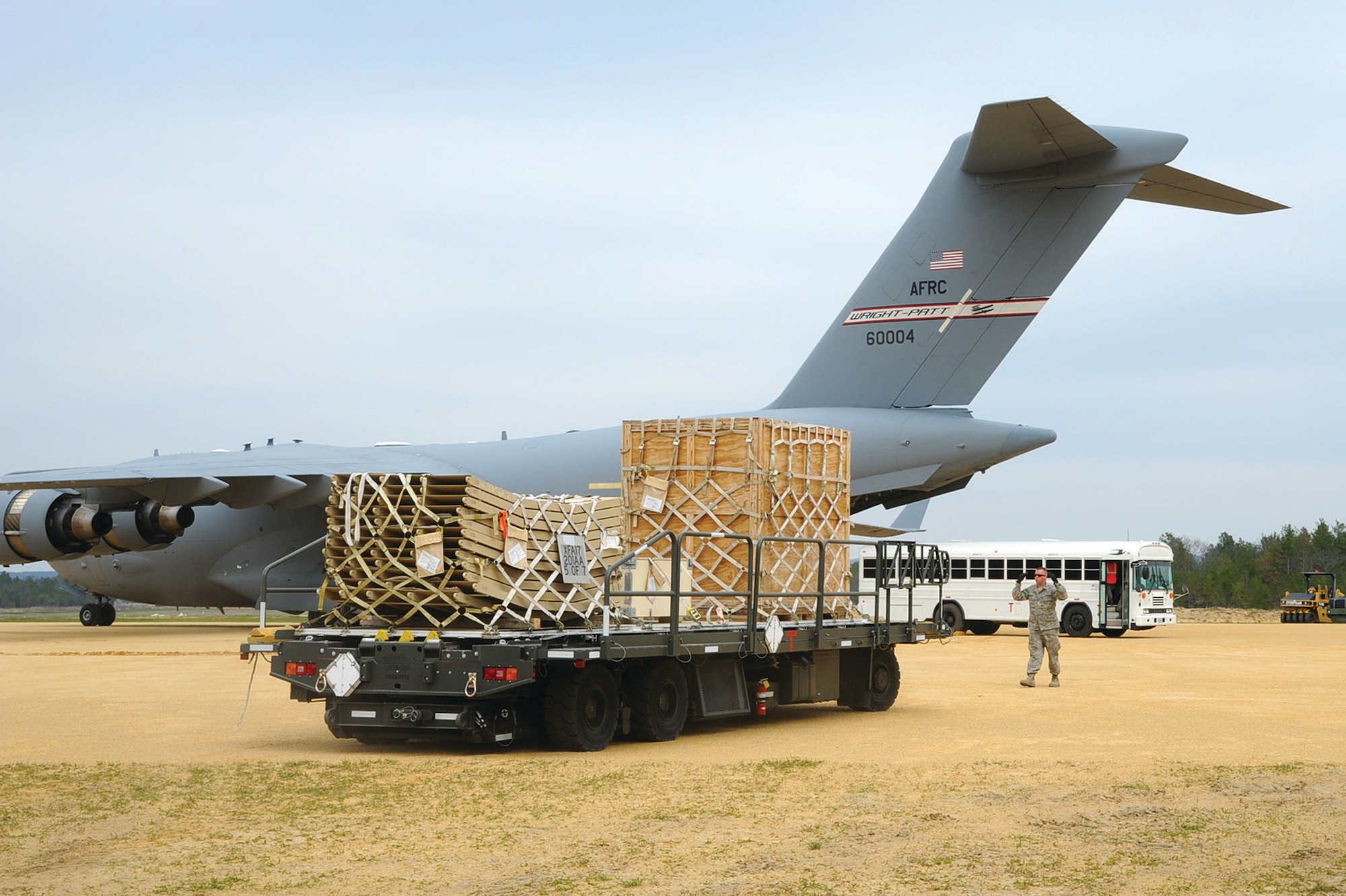 U.S. Air Force Staff Sgt. Chris Barnum, 30th Aerial Port Squadron, Niagara Falls Air Reserve Station, N.Y. marshals in a load of cargo on to a 445th Airlift Wing C-17 Globemaster III May 7, 2014 during exercise Patriot Warrior at Fort McCoy, Wis. United States military reserve components from all branches participate in combined exercises Patriot Warrior, Global Medic, Diamond Saber and CSTX in preparation for upcoming deployments in joint environments. (U.S. Air Force photo by Master Sgt. Francisco V. Govea II/ Released)