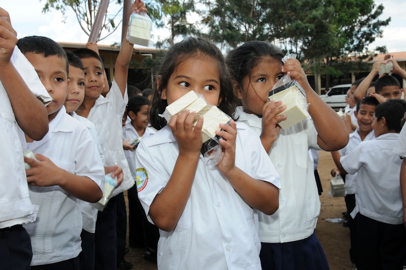 A student at the Ramon Calix Figueroa school enjoys the scent of the soap she just received.  Joint Task Force-Bravo, non-government organizations Clean the World, Bridge Ministries and Kick for Nick Foundation, the Honduran 21st Military Police Battalion and the Honduran National Police formed a partnership to distribute soap kits, backpacks with school supplies, tooth brushes and tooth paste, soccer balls and uniforms to students at eight Tegucigalpa, Honduras schools in a two-day event, May 20-21, 2014.  The group handed out over 4,200 soap kits, 600 backpacks, 150 tooth brushes and tooth paste, and 50 soccer balls.  (Photo by U. S. Air National Guard Capt. Steven Stubbs)