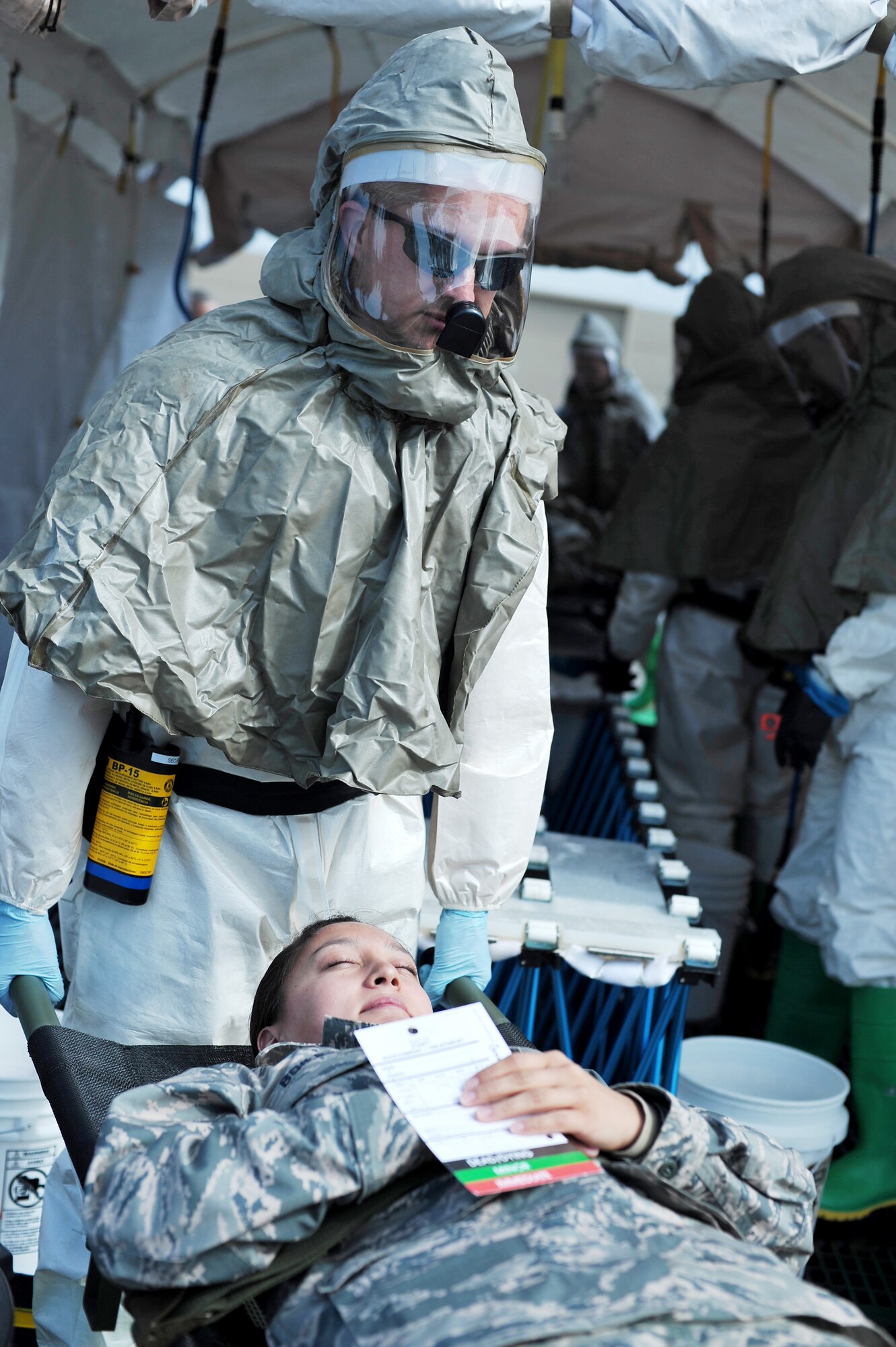 U.S. Air Force Capt. Jeremy Matis, 354th Medical Operations Squadron dentist, transports Senior Airman Heather Boiles 354th MDOS medical standards management element, during a chemical, biological, radiological and nuclear medical training exercise May 21, 2014, Eielson Air Force Base, Alaska. The exercise simulated the effects of aqueous ammonia on a population and tested the response capabilities of the 354th Medical Group. (U.S. Air Force photo by Staff Sgt. Jim Araos/Released)