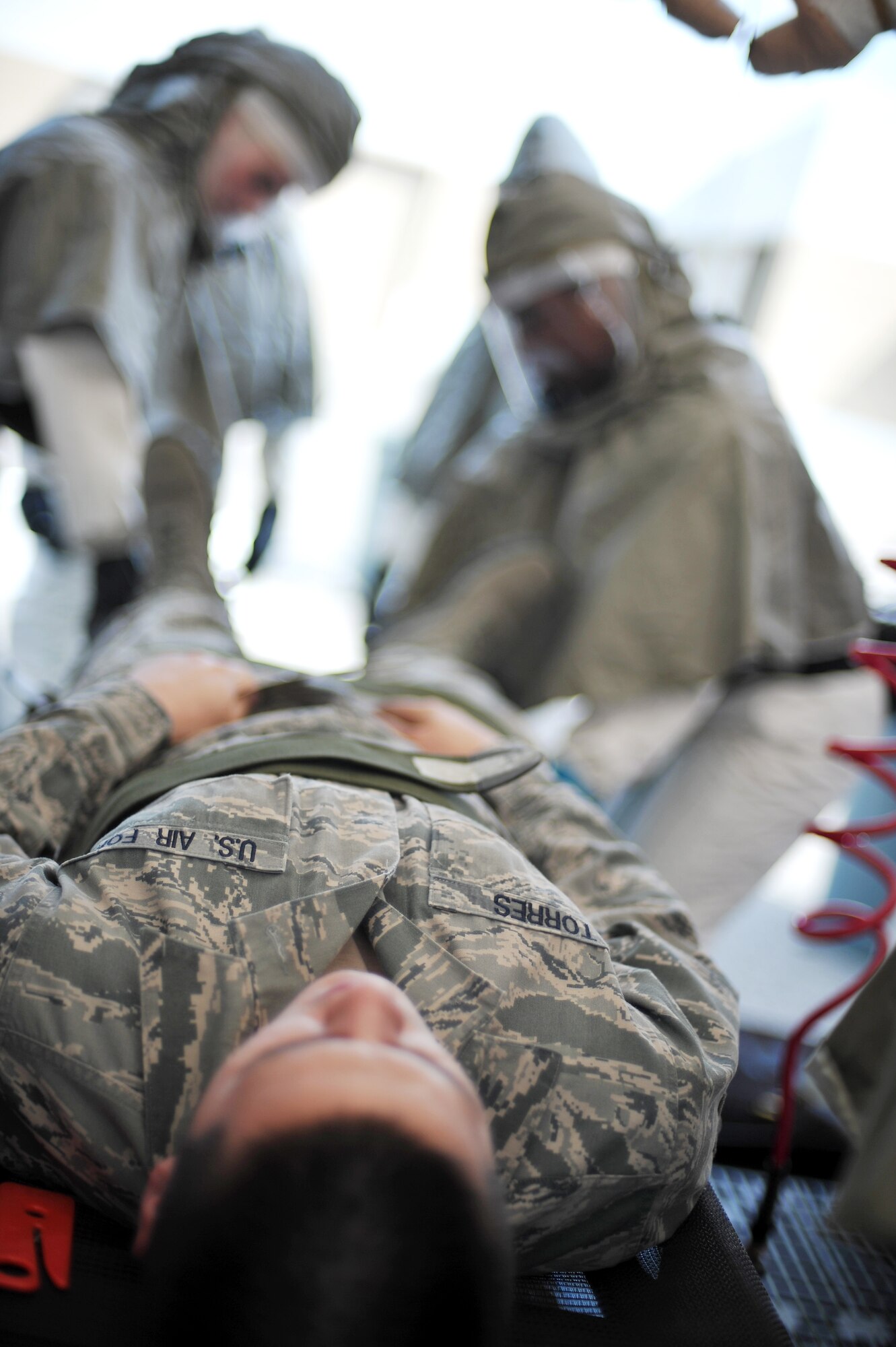 U.S. Air Force Senior Airman Vito Torres, 354th Medical Operations Squadron unit deployment manager, undergoes an in-place patient decontamination process during a chemical, biological, radiological and nuclear medical training exercise May 21, 2014, Eielson Air Force Base, Alaska. An in-place patient decontamination shelter decontaminates ambulatory and non-ambulatory patients and casualties affected by CBRN contamination. (U.S. Air Force photo by Staff Sgt. Jim Araos/Released)