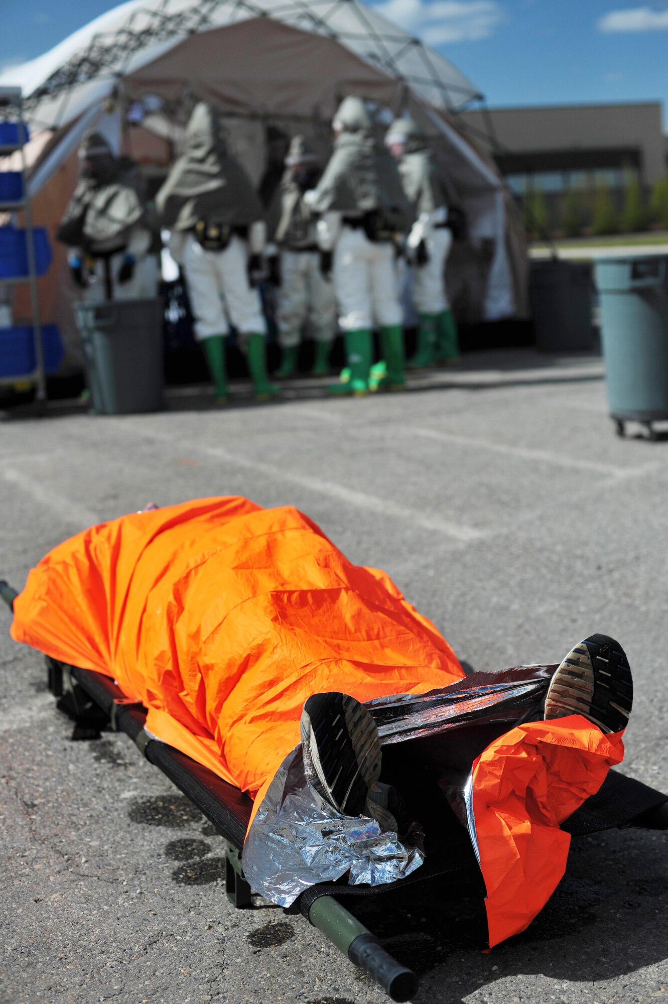 U.S. Air Force Staff Sgt. Adam Whiffen, 354th Medical Operations Squadron immunizations technician, simulates chemical injuries while wrapped in a space blanket during a chemical, biological, radiological and nuclear medical training exercise May 21, 2014, Eielson Air Force Base, Alaska. A space blanket is a heat-reflective thin plastic sheet designed to reduce heat loss in a person’s body. (U.S. Air Force photo by Staff Sgt. Jim Araos/Released)