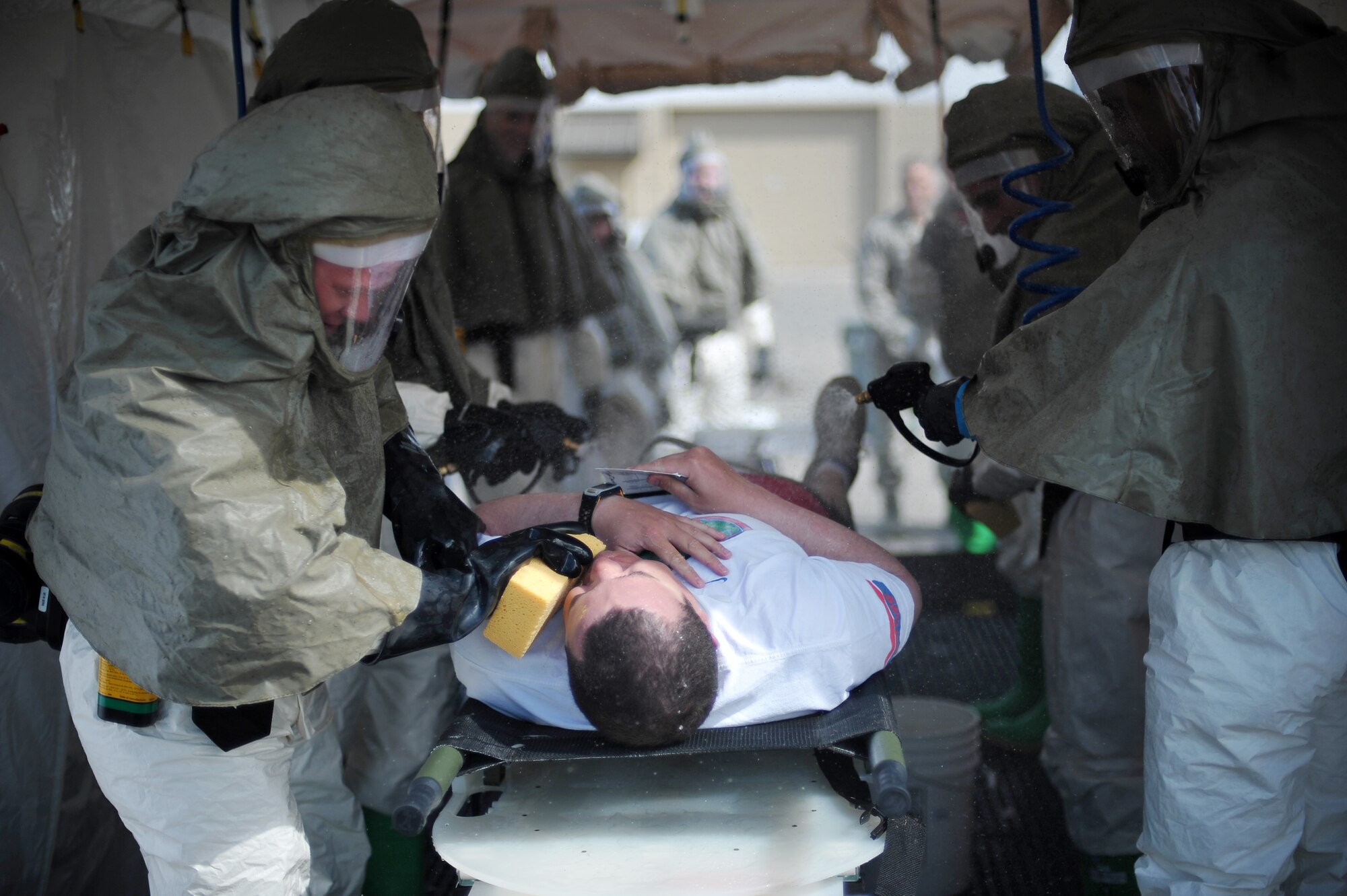 U.S. Air Force Staff Sgt. Adam Whiffen, 354th Medical Operations Squadron immunizations technician, goes through an in-place patient decontamination shelter during a chemical, biological, radiological and nuclear medical training exercise May 21, 2014, Eielson Air Force Base, Alaska. Medical Counter CBRN equipment packages are utilized throughout the Air Force to support domestic operations involving accidental or intentional terrorist use of CBRN materials. (U.S. Air Force photo by Staff Sgt. Jim Araos/Released)