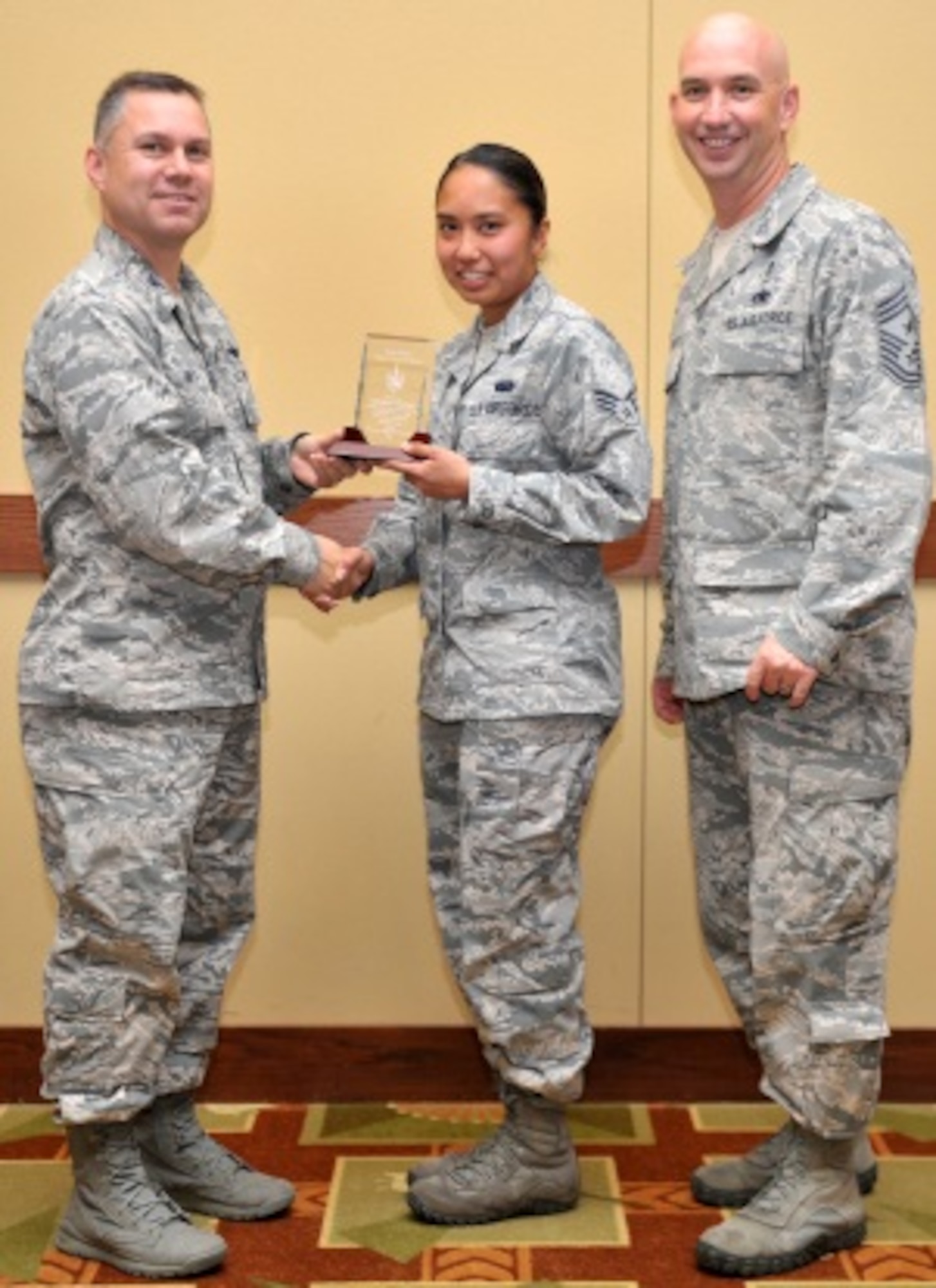 Col. William Holt, 1st Special Operations Wing vice commander, presents the 2014 Hurlburt Field Active Duty Angel Award to Senior Airman Rayna Yamamoto, 1st Special Operations Communication Squadron communications program manager, during the 2014 Volunteer Recognition Ceremony at the Soundside Club on Hurlburt Field, Fla., May 22, 2014. “Some of my favorite events to volunteer for are the obstacle courses and casino nights,” said Yamamoto. (U.S. Air Force photo/Senior Airman Kentavist P. Brackin)