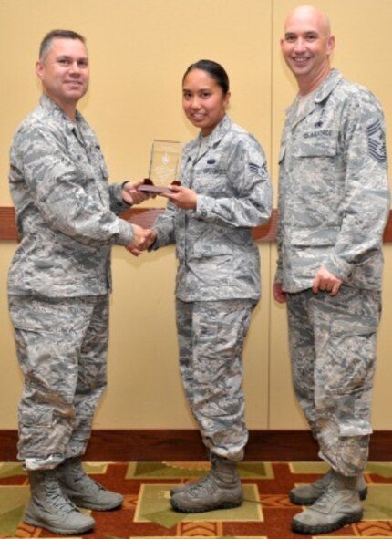 Col. William Holt, 1st Special Operations Wing vice commander, presents the 2014 Hurlburt Field Active Duty Angel Award to Senior Airman Rayna Yamamoto, 1st Special Operations Communication Squadron communications program manager, during the 2014 Volunteer Recognition Ceremony at the Soundside Club on Hurlburt Field, Fla., May 22, 2014. “Some of my favorite events to volunteer for are the obstacle courses and casino nights,” said Yamamoto. (U.S. Air Force photo/Senior Airman Kentavist P. Brackin)
