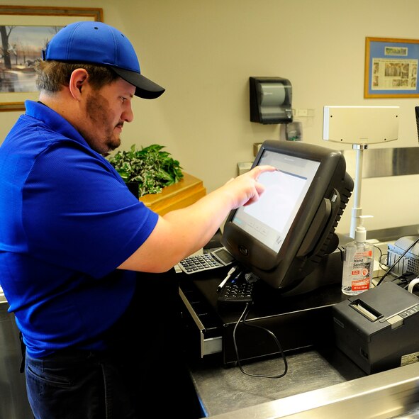 Patrick Tremper, Elkhorn Dining Facility cashier, prepares his station to sign in customers before opening for lunch at the DFAC at Malmstrom Air Force Base May 27. Civilians work hand in hand with Airmen throughout the duty day to serve Malmstrom’s active duty personnel and retirees while also hosting luncheons for a wide array of special events. (U.S. Air Force photo/Airman 1st Class Collin Schmidt)