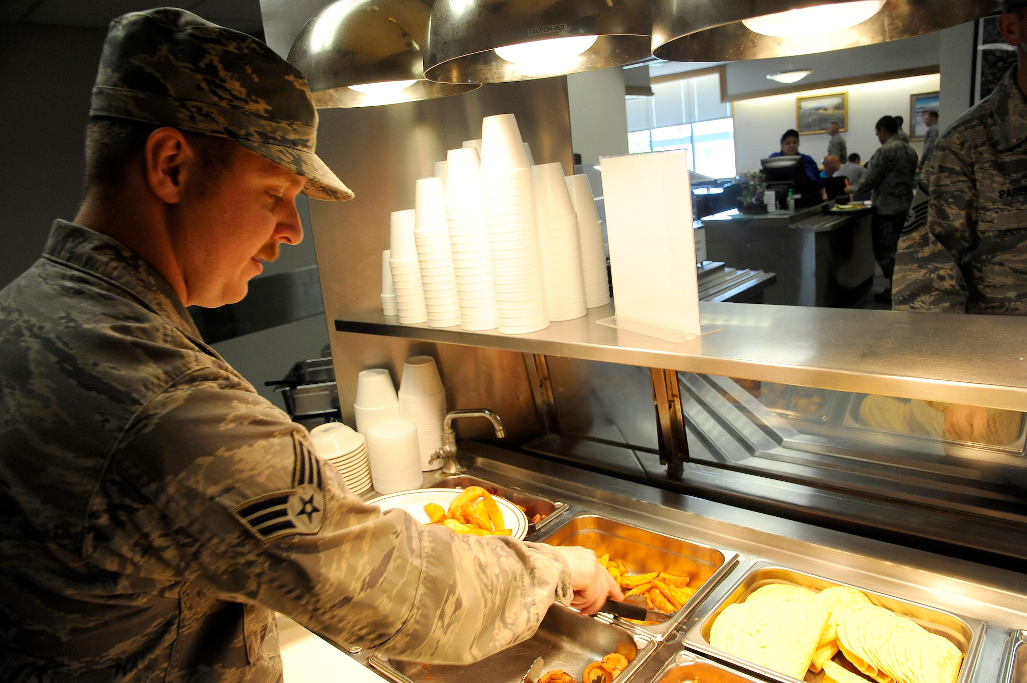 Senior Airman Kyle Fritz, 341st Force Support Squadron food service journeyman, prepares a plate for a customer during lunch at Malmstrom’s Elkhorn Dining Facility on May 27. After breakfast, lunch and dinner the process of cleaning, cooking and preparation for the next day’s courses starts all over again. (U.S. Air Force photo/Airman 1st Class Collin Schmidt)