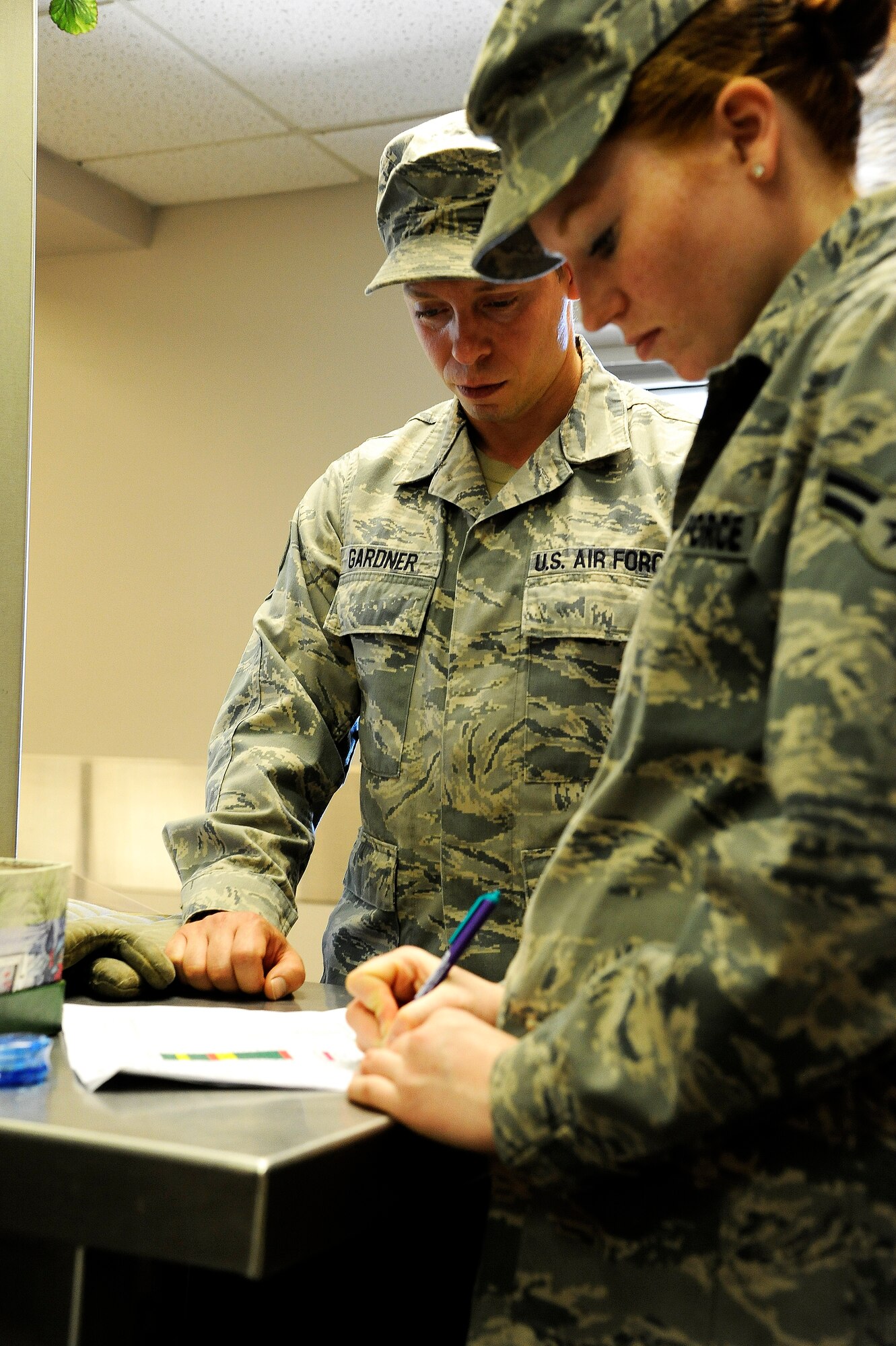 Staff Sgt. Eldoris Gardner, 341st Force Support Squadron food service craftsman, and Airman 1st Class Teresa McOsker, 341st FSS food service apprentice, review a list of food items needing to be restocked after lunch at the Elkhorn Dining Facility May 27. After each mealtime, a detailed checklist is followed to ensure quality and temperatures are checked for all heat sensitive food products. (U.S. Air Force photo/Airman 1st Class Collin Schmidt)