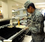 Senior Airman Juan Cimental, 341st Force Support Squadron chef, Grills chicken in preparation for lunch at the Elkhorn Dining Facility May 27. Throughout the day, dining facility personnel serve nearly 400 Airmen, retirees and guests of Malmstrom Air Force Base. (U.S. Air Force photo/Airman 1st Class Collin Schmidt)