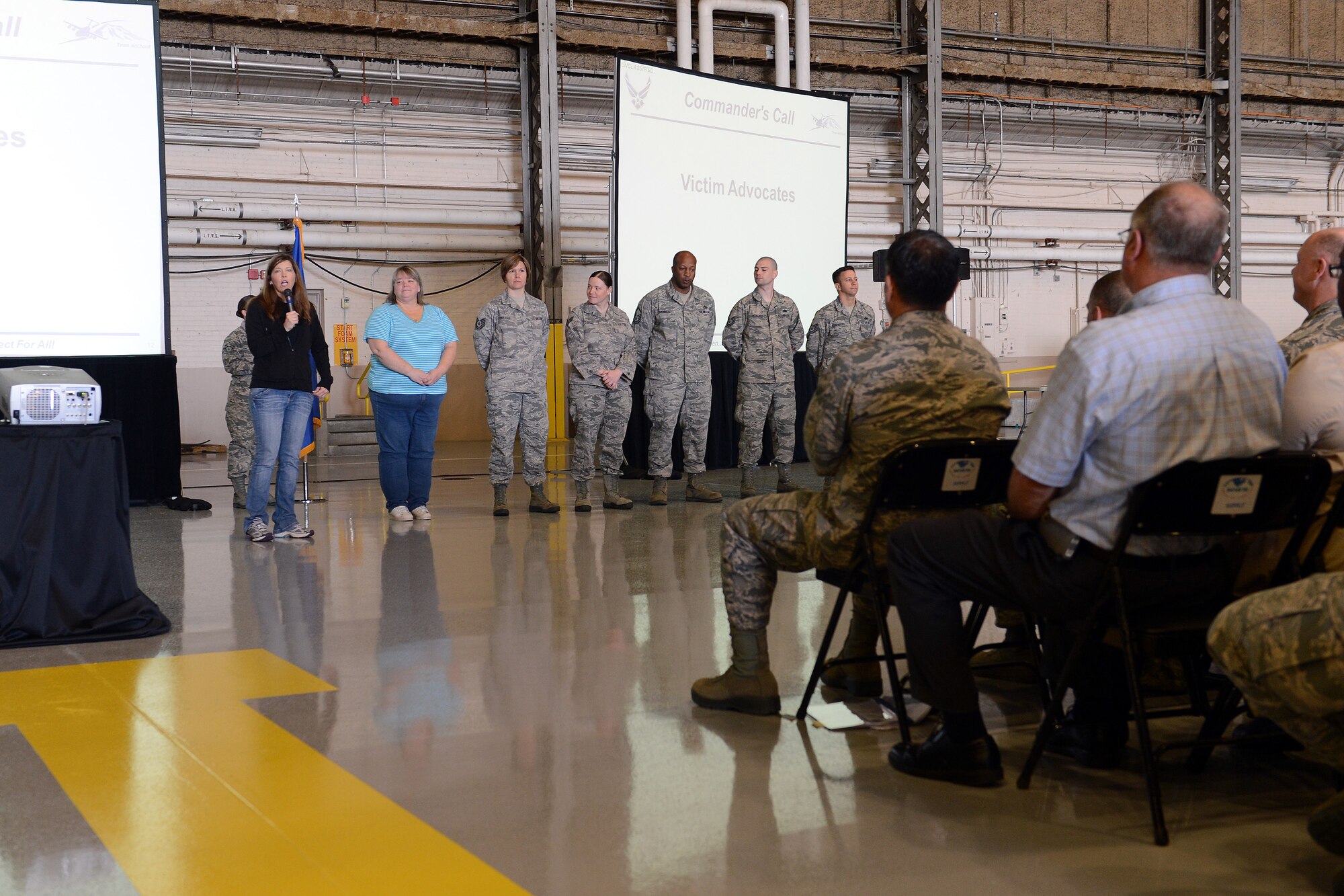 Heather Van Mill (far left), 62nd Airlift Wing sexual assault response coordinator, introduces Team McChord’s victim advocates to Airmen and civilians participating in the Sexual Assault Response and Prevention down day May 22, 2014, at Joint Base Lewis-McChord, Wash. The SAPR down day focused on the theme “Duty to Intervene”, the power of one and instilling a culture of dignity and respect. (U.S. Air Force photo/Airman 1st Class Jacob Jimenez)
