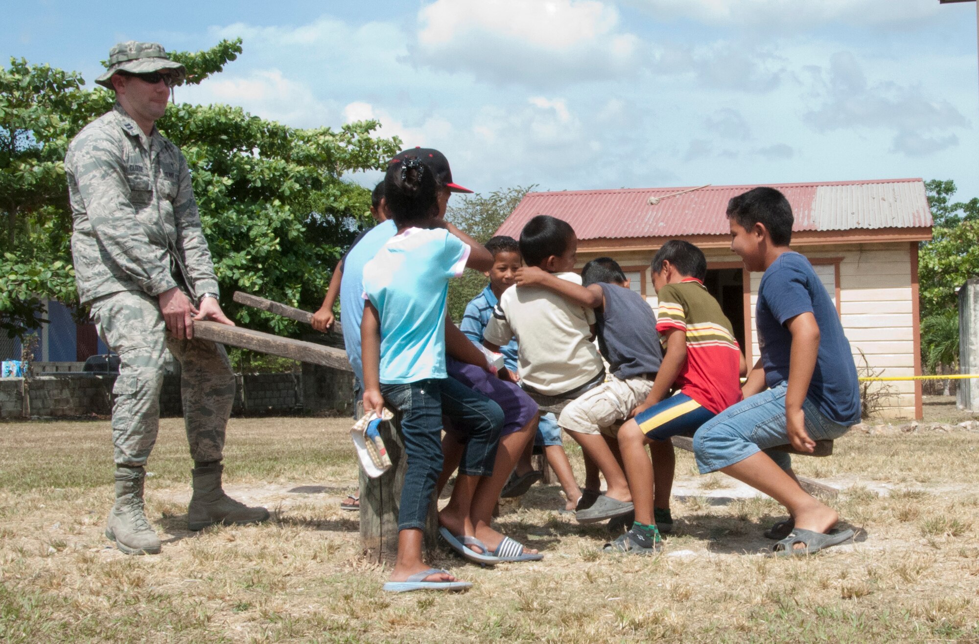 U.S. Air Force Chaplain (Capt.) Matthew Clouse, right, plays on a seesaw with Belizean children while they wait with their parents to receive medical care during a New Horizons Belize 2014 medical readiness training exercise, or MEDRETE, April 11, 2014, in Progresso, Belize. Clouse is supporting service members of New Horizons Belize 2014 as the team's chaplain. He is charged with meeting the spiritual needs of the more than 400 U.S. military members deployed in support of the exercise. (U.S. Air Force photo by Tech. Sgt. Kali L. Gradishar/Released)