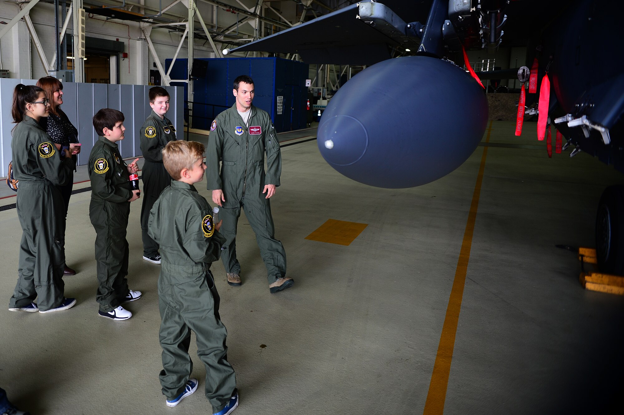 Maj. Jason Bianchi, 493rd Fighter Squadron pilot, explains how much fuel an F-15C Eagle can hold during a “Pilot for a Day” event at Royal Air Force Lakenheath, England, May 22, 2014. The program gives local children with serious illnesses and conditions a day away from routine hospital visits and the opportunity to see the Air Force mission up close. (U.S. Air Force photo by Staff Sgt. Emerson Nuñez/Released)