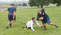 An Airman with the 436th Maintenance Squadron takes the flags off his opponent a 736th Aircraft Maintenance Squadron Airman, while playing flag football during Dover Air Force Base Wingman Day May 22, 2014, at Dover AFB, Del. MXS beat AMXS 12-7 advancing them to the next level. (U.S. Air Force photo/Senior Airman Jared Duhon)