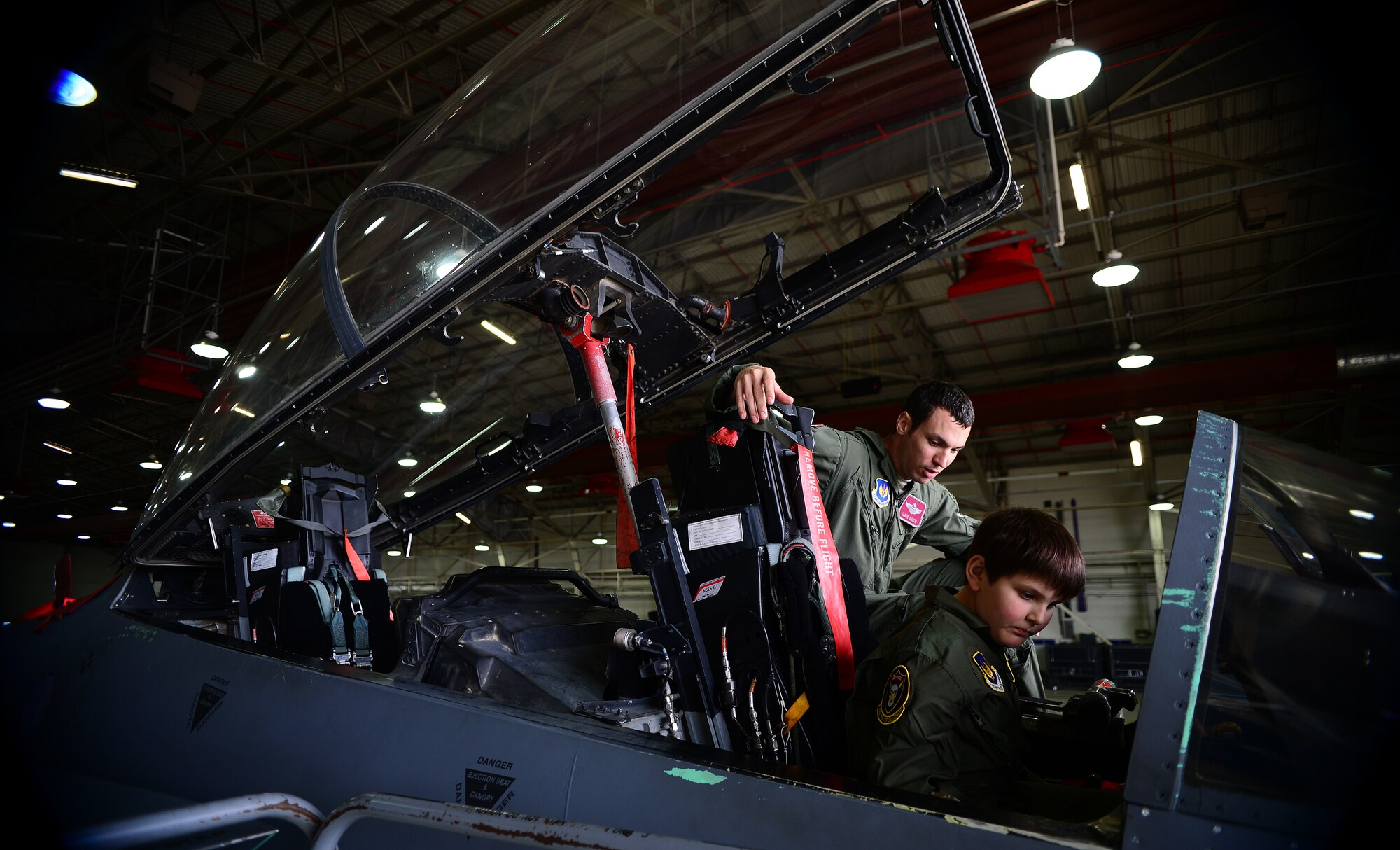 Maj. Jason Bianchi, 493rd Fighter Squadron pilot, shows Daniel Blackshaw, 10, the cockpit of an F-15C Eagle during a “Pilot for a Day” event at Royal Air Force Lakenheath, England, May 22, 2014. Children received customized flight suits, a flight in an F-15 simulator, an interactive squadron tour and an up-close viewing of a jet. (U.S. Air Force photo by Staff Sgt. Emerson Nuñez/Released)