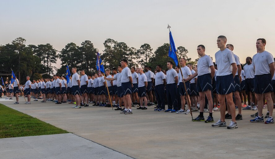 Airmen stand at parade rest at the President George W. Bush Air Park on Moody Air Force Base, Ga., May 22, 2014. Airmen were awaiting instructions before starting their Comprehensive Airmen Fitness day activities. (U.S. Air Force photo by Airman 1st Class Alexis Millican/Released)