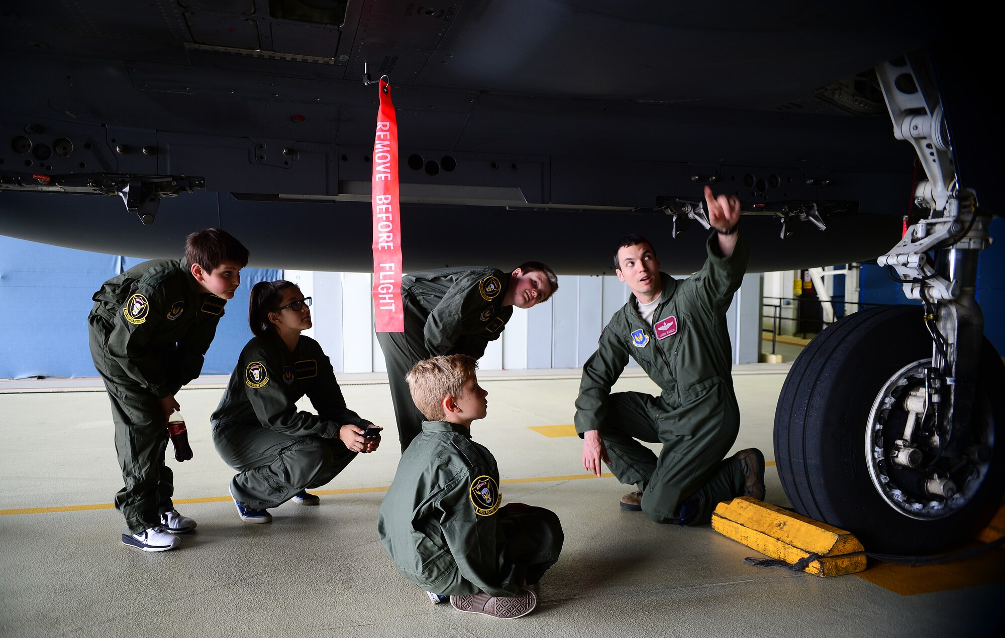 Maj. Jason Bianchi, 493rd Fighter Squadron pilot, explains the different parts of an F-15C Eagle during a “Pilot for a Day” event at Royal Air Force Lakenheath, England, May 22, 2014. The program started at RAF Lakenheath in March 2012 with the intent to assist children throughout local communities who are fighting life-threatening illnesses or conditions. This day of fun allowed for aa break from routine doctor and hospital visits. (U.S. Air Force photo by Staff Sgt. Emerson Nuñez/Released)