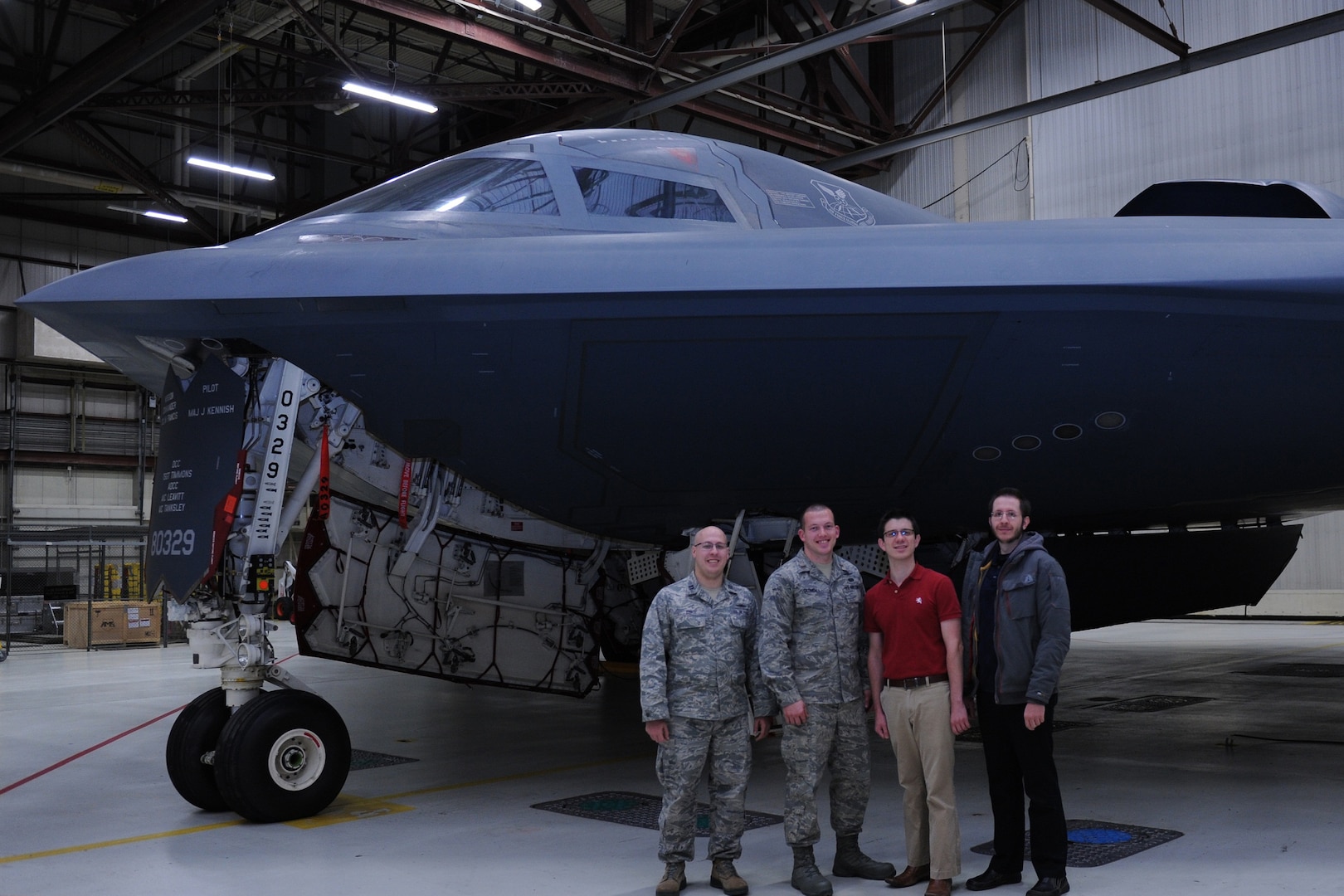 2nd Lt. Curan Clonch (left center) poses in front of a B-2 bomber at Whiteman Air Force Base, Missouri.  (U.S. Air Force courtesy photo)