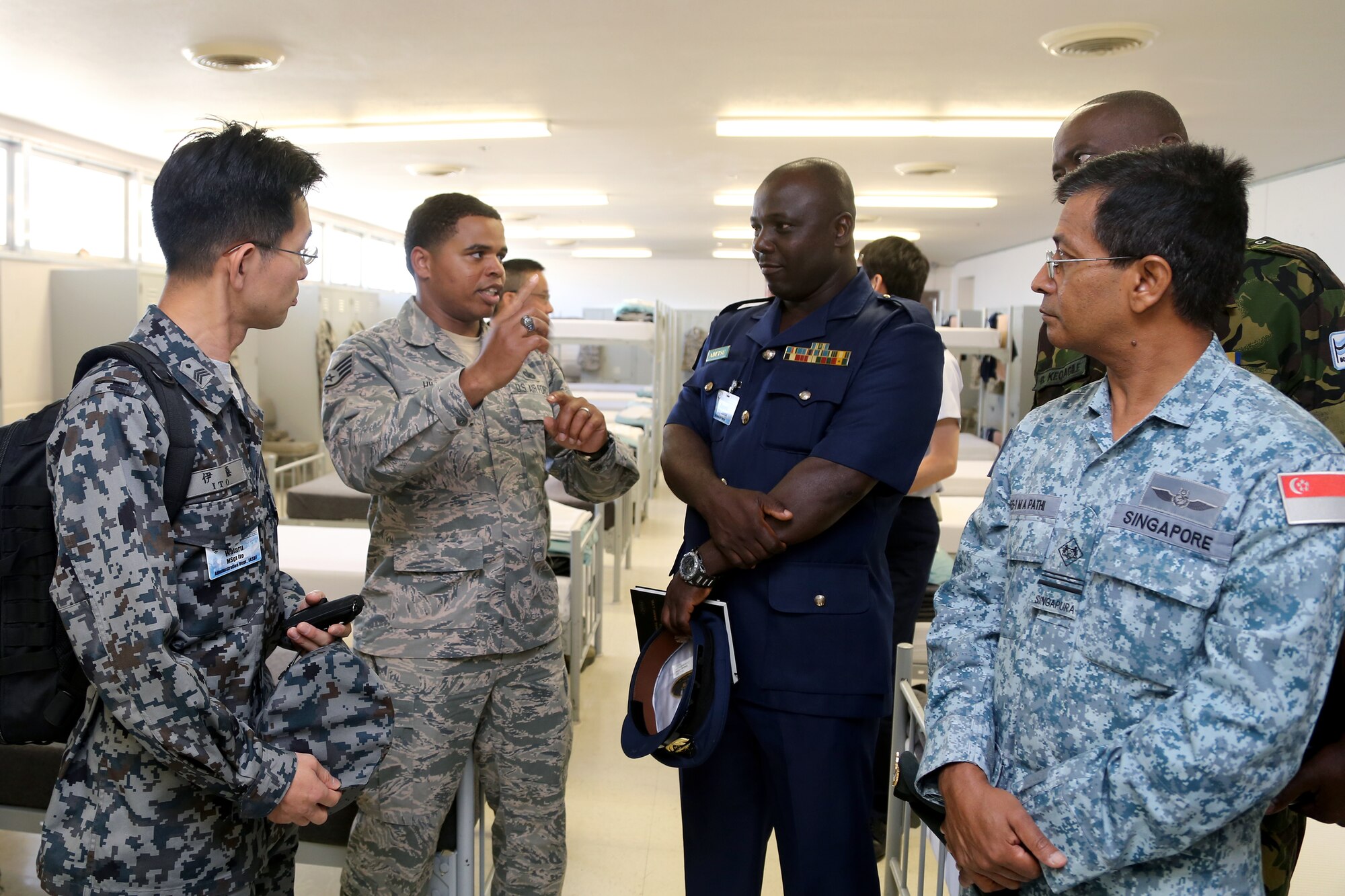 A Military Training Instructor speaks with senior enlisted leaders from the air forces of 24 countries as they tour basic military training facilities at Joint Base San Antonio-Lackland, Texas. Chief Master Sgt. of the Air Force James Cody hosted an international senior enlisted leader summit May 13-16. (U.S. Air Force photo by Joshua Rodriguez)