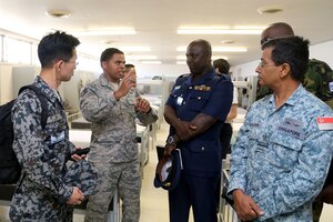 A Military Training Instructor speaks with senior enlisted leaders from the air forces of 24 countries as they tour basic military training facilities at Joint Base San Antonio-Lackland, Texas. Chief Master Sgt. of the Air Force James Cody hosted an international senior enlisted leader summit May 13-16. (U.S. Air Force photo by Joshua Rodriguez)
