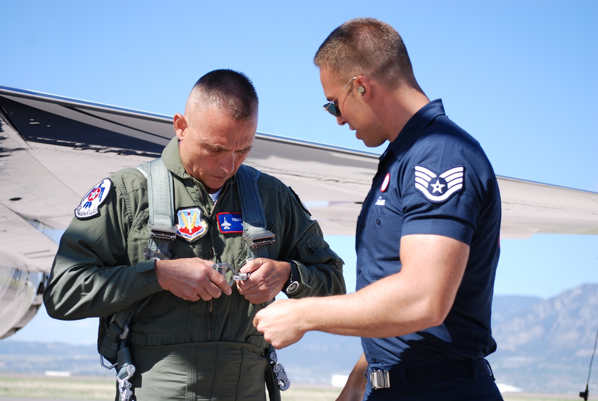 PETERSON AIR FORCE BASE, Colo. – Chief Christopher Riley, with the Colorado Springs Fire Department, fastens his restraint harness after putting on a gravity-suit May 27, in preparation for a ride in an F-16 Fighting Falcon, the aircraft flown by the U.S. Air Force Thunderbirds. The flying unit, officially known as the U.S. Air Force Air Demonstration Squadron, was at Peterson AFB to perform at this year’s Air Force Academy graduation ceremony May 28. Riley was selected for the exciting ride-along for his contribution to our community and the surrounding Pikes Peak Region. (U.S. Air Force photo/Michael Golembesky)