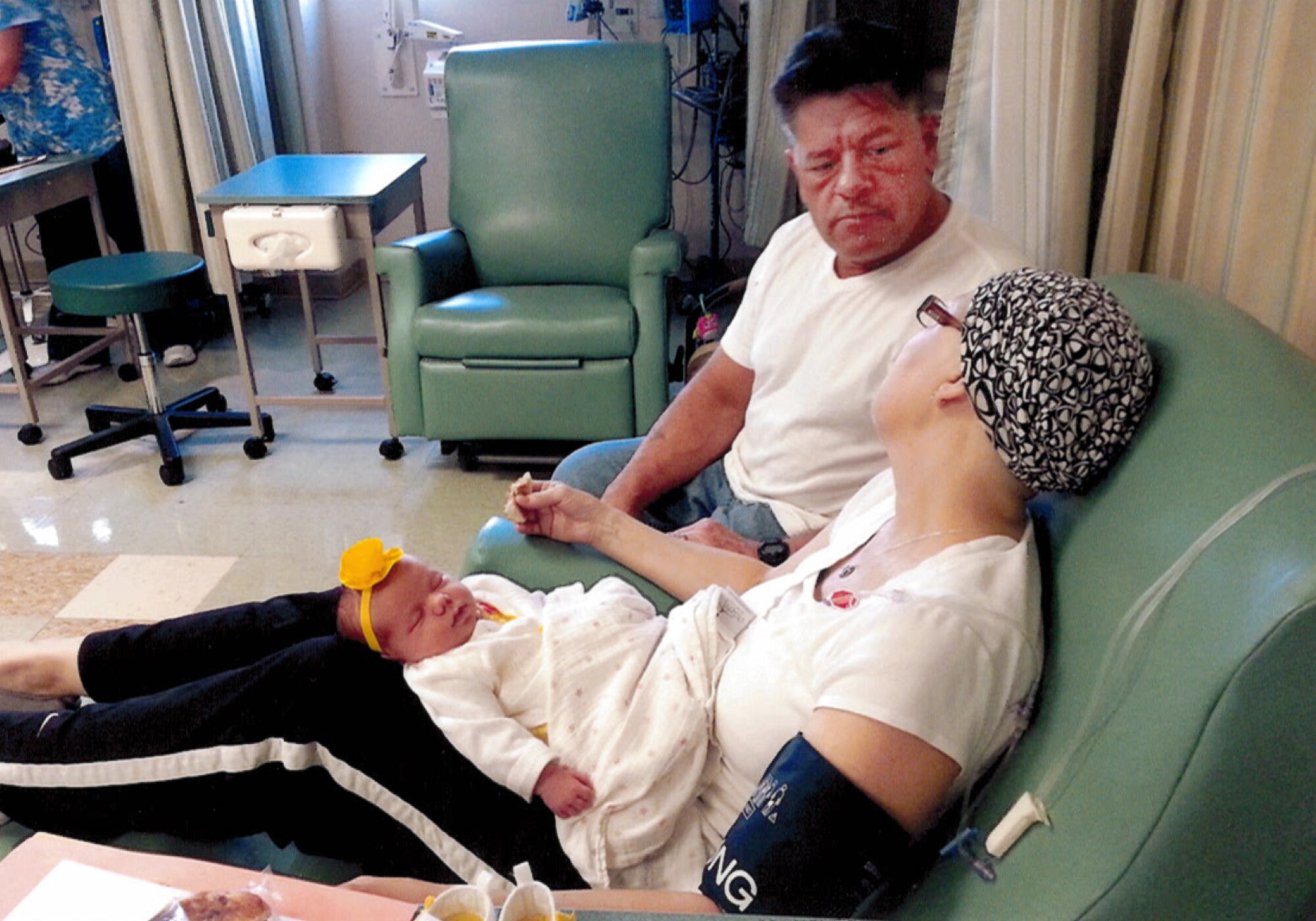 Senior Master Sgt. Dale Przyojski holds her granddaughter during a chemo session.  (Courtesy photo/Released)