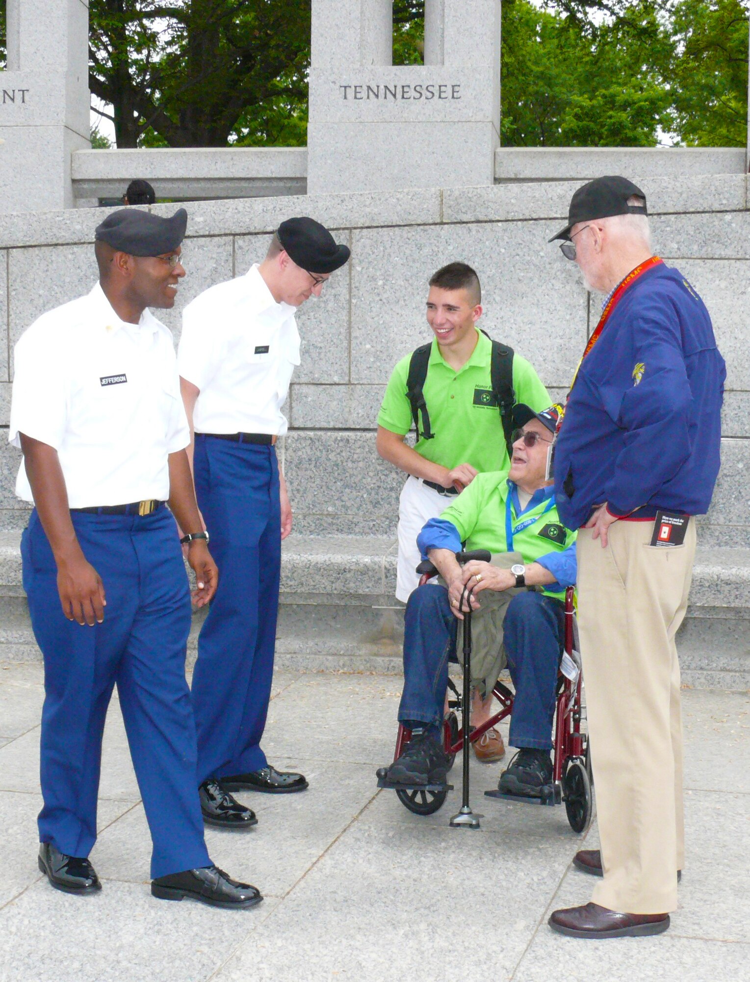 Tullahoma High School senior Jonathan Fearing (third from left) escorts his grandfather Herb Fearing of Tullahoma (in wheelchair) on the Honor Flight of World War II and Korean War veterans while he talks with two soldiers from Ft. Gordon, Ga. and Herb’s college fraternity brother (right). (Photo by Claude Morse)