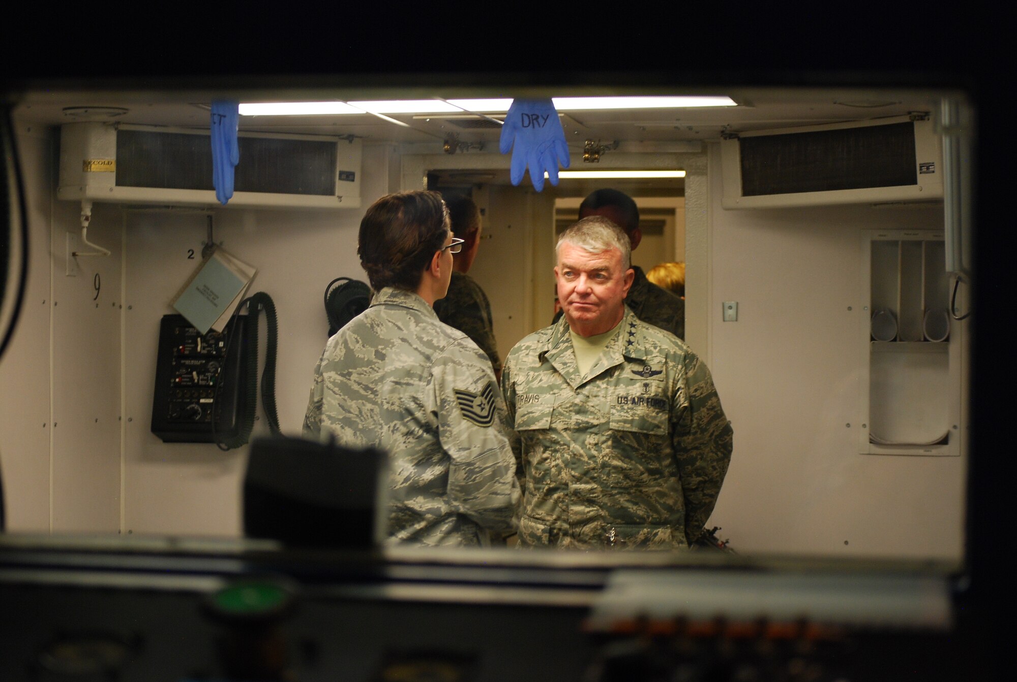 PETERSON AIR FORCE BASE, Colo. – Lt. Gen. Thomas Travis, Air Force Surgeon General, listens to an operations brief inside the altitude chamber during his visit to the 21st Aerospace Medicine Squadron May 22. Travis toured various areas of the 21st Medical Group where he learned about 21st MDG plans, interacted with Airmen, addressed concerns and learned about specific jobs. (U.S. Air Force photo/Michael Golembesky)