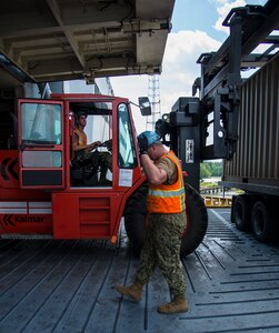 Sailors unload cargo during Exercise Turbo Distribution, a U.S. Transportation Command,  exercise May 21, 2014, aboard the USNS Watkins (T-AKR-315), moored at Wharf Alfa on Joint Base Charleston, S.C. Held May 15 through 22, Exercise Turbo Diesel allowed members of TRANSCOM’s 597th Transportation Battalion, Military Sealift Command’s Expeditionary Port Unit 110, Naval Cargo Handling Battalion One, along with JB Charleston’s 841st TB and ASLAC, the opportunity to exercise their skills on a joint envoironment. (U.S. Air Force photo/ Airman 1st Class Clayton Cupit)