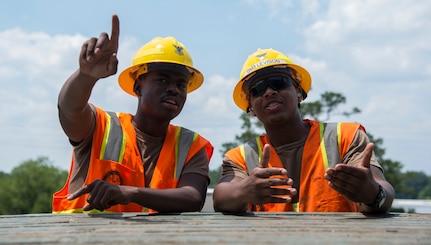 Two Sailors talk during Exercise Turbo Distribution, a U.S. Transporation Command exercise May 21, 2014, aboard the USNS Watkins (T-AKR-315), moored at Wharf Alfa on Joint Base Charleston, S.C. Held May 15 through 22, Exercise Turbo Diesel allowed members of TRANSCOM’s 597th Transportation Battalion, Military Sealift Command’s Expeditionary Port Unit 110, Naval Cargo Handling Battalion One, along with JB Charleston’s 841st TB and ASLAC, the opportunity to exercise their skills in a joint envoironment. (U.S. Air Force photo/ Airman 1st Class Clayton Cupit)