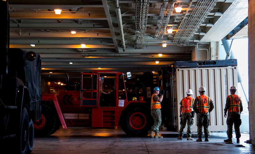 Sailors unload cargo during Exercise Turbo Distribution, a U.S. Transportation Command exercise May 21, 2014, aboard the USNS Watkins (T-AKR-315), moored at Wharf Alfa on Joint Base Charleston, S.C. Held May 15 through 22, Exercise Turbo Diesel allowed members of TRANSCOM’s 597th Transportation Battalion, Military Sealift Command’s Expeditionary Port Unit 110, Naval Cargo Handling Battalion One, along with JB Charleston’s 841st TB and ASLAC, the opportunity to exercise their skills in a joint envoironment. (U.S. Air Force photo/ Airman 1st Class Clayton Cupit)